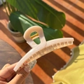 Detailed close-up of cream butterfly hair claw clip with metallic spring mechanism - Cream