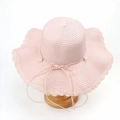 Detail of pink straw hat featuring scalloped wavy edges and delicate pearl bow decoration - M (56-58cm) / Pink