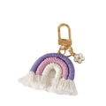 Detail of handmade cotton rainbow keychain with purple tassels and a floral charm pendant - Dark Violet