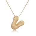 Gold plated initial V pendant necklace with micro-pave crystals on white background - Letter V
