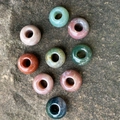 Natural gemstone abacus beads in mixed colors on stone background for DIY jewelry - India Agate