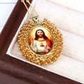 Close-up of golden Sacred Heart of Jesus oval pendant with colorful beads and chain - Gold
