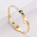 Elegant gold titanium bangle with sparkling rhinestones and black leather strap buckle - Gold