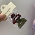 Detail of two solid jelly mini hair clips in burgundy and dark green colors on a card - Small Semicircle (Wine Red + Grass Green)