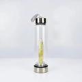 Glass energy water bottle with yellow crystal stones and metal cap on white background - Citrine
