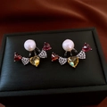 Detail shot of multi-color heart studs with pearls on textured black jewelry box - Black-Multicolor (Heart Pearl Patchwork)