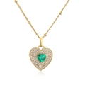 Macro detail of 18K gold plated heart necklace with green zircon and micro pavé stones - Gold Heart Green Stone