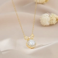 Detailed macro view of a gold-plated bow necklace with sparkling zircon pendant - Clear Zirconia Style / Gold (XL63266)