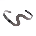 Macro detail of wave-shaped open bracelet with smooth polished black finish - Gun Black Polished Wavy Open Bangle (10500)