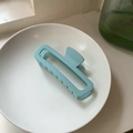Matte light blue rectangular claw clip in a white ceramic bowl on a windowsill - Light Blue