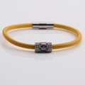 Detail of yellow braided leather bracelet with silver bead and purple stone inlay - Bright Yellow Leather + Silver Charm