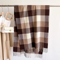 Thick plaid scarf in brown and cream with fringe, hanging on a metal hanger - Camel & Coffee Plaid