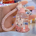 Detail of creative tiger keychain with pink liquid glitter and beaded wristlet strap - Bucket