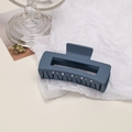 Macro detail of large matte navy blue square hair claw clip on a minimalist white backdrop - Cube / Navy Blue
