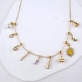 Golden multi-charm chain necklace featuring pearls and colorful heart-shaped pendants - Gold Finished Multi-Charm Necklace