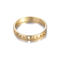 Close-up of golden ring featuring hollowed-out star and moon celestial patterns - Star & Moon Hollow