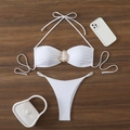 Flat lay of white halter bikini with gold metal ring detail on dark wood background - S / White
