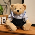 Brown teddy bear plush in blue striped shirt and navy pleated skirt on wooden table - Blue Striped Suit - Female / 25cm