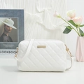 White quilted rhombic crossbody bag with golden hardware and adjustable leather strap - White