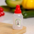 Mini plastic soy sauce squeeze bottle with a red cap on a wooden cutting board - Soy Sauce Single Bulk