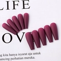 Detailed view of dark purple matte press-on nails arranged on a white background - Fuschia