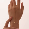 Detail of 18K gold plated double layer slave bracelet featuring dainty beads and finger ring - Bead Fine Chain / Gold