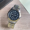 Detail of quartz watch with black dial and elastic metal band on wooden background - Men's Watch / Two-tone Band Black Dial