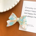 Pink and blue marble texture acetate bow hair clip with pearl center on leather background - Floral Pink Blue