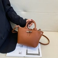 Retro brown bucket bag with bamboo clasp in pebble leather and long shoulder strap - Small / Brown