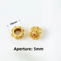 Detailed macro view of 10mm gold hollow charms with red and white zircon inlays - Style 11 Large Hole Cylinder-Aperture 5mm