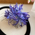 Detailed macro view of deep blue gradient fabric spider lily hair clip on a vintage base - Claw Clip Style / Purple