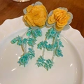 Close-up of yellow fabric flower earrings with green beaded tassels on a white plate - 28# Silver Needle-Green (Flower Tassel)