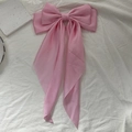 Elegant large pink silk bow hair clip with long ribbons on a white textured background - Light Pink