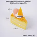 Triangle yellow mousse cake toy with cream topping and orange slice decoration - Yellow