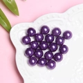 Vibrant purple ABS faux pearls in a white ceramic dish for DIY craft accessories - Violet