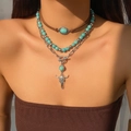 Close-up of bohemian layered necklace set with turquoise beads and bull head pendant - 3-Layer Brown Leather Bull Symbol Turquoise Style