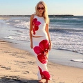 Casual white two-piece set with red orchid print featuring slim vest and long skirt on a beach - S / White