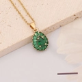 Macro shot of a vintage gold necklace with pear-shaped emerald and baguette-cut stones - Retro Teardrop Cluster Style (8#)