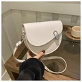 Chic cream-white saddle bag with silver clasp shown on a rustic wooden table - Off White
