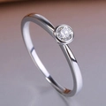 Minimalist silver ring with a single round cut diamond in a sleek bezel setting - White Gold / US 7