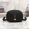 Black shell crossbody bag with V-shaped quilting and pearl pendant on wide strap - Black