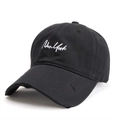 Close-up of New York embroidery and distressed frayed brim on black cotton baseball cap - Black