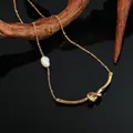 Collar bohemio de cuentas doradas con colgante de nudo metálico y detalle de perla blanca - Collar con Colgante de Perla y Nudo Dorado