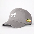 Detailed close-up of grey twill baseball cap featuring white A embroidery and side badge - Gray