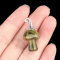 Green crystal mushroom pendant with silver metal cap shown on finger for scale - Gun Black Cap / Unakite