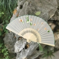 Traditional Suzhou embroidered folding silk fan with green ginkgo leaf patterns and tassel - Ginkgo