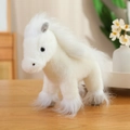 Cute white plush pony doll with fluffy mane and soft fur on a wooden table - White Horse Doll