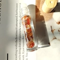 Glass essential oil roller bottle with orange crystal stones and wooden cap - Red Agate