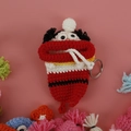 Handmade crochet doll key case with big lips and white hat in red and black yarn - Red Christmas with Braids