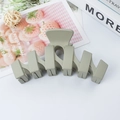 Light green wave-shaped matte hair claw clip for elegant bun styling on white background - Grey Green
